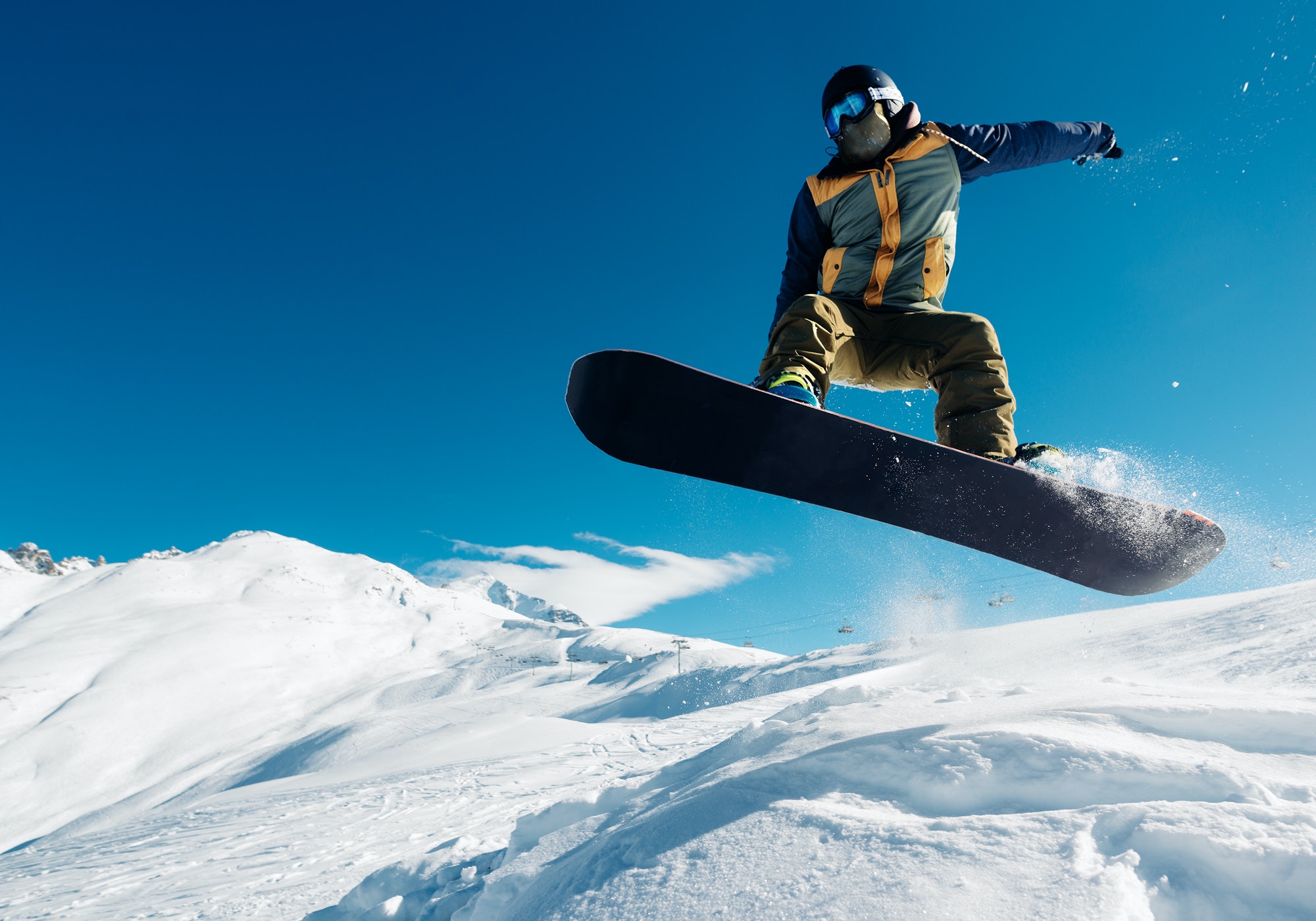 snowboarder is jumping with snowboard from snowhill